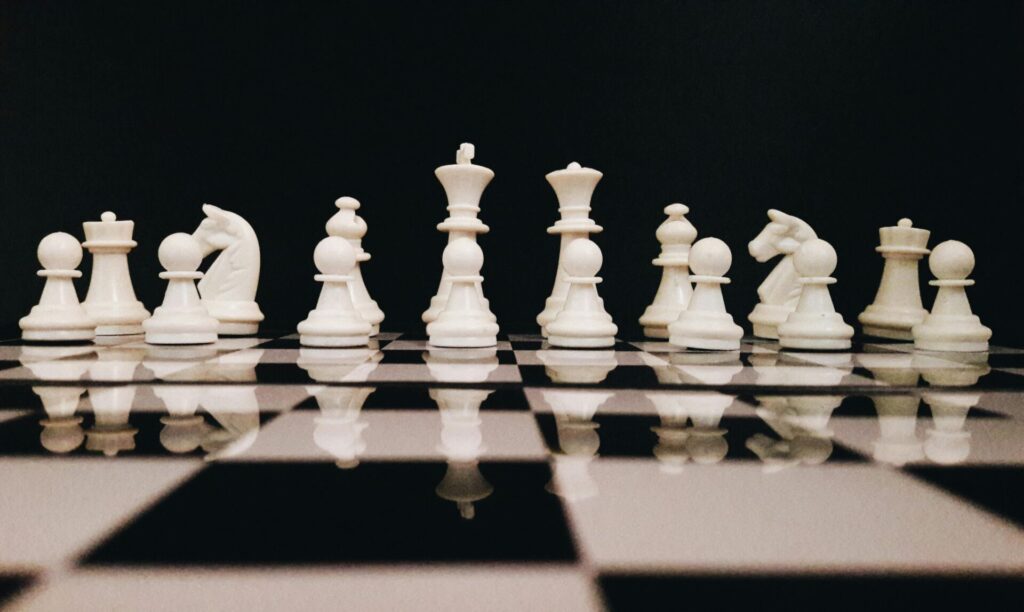 white game pieces on a chessboard